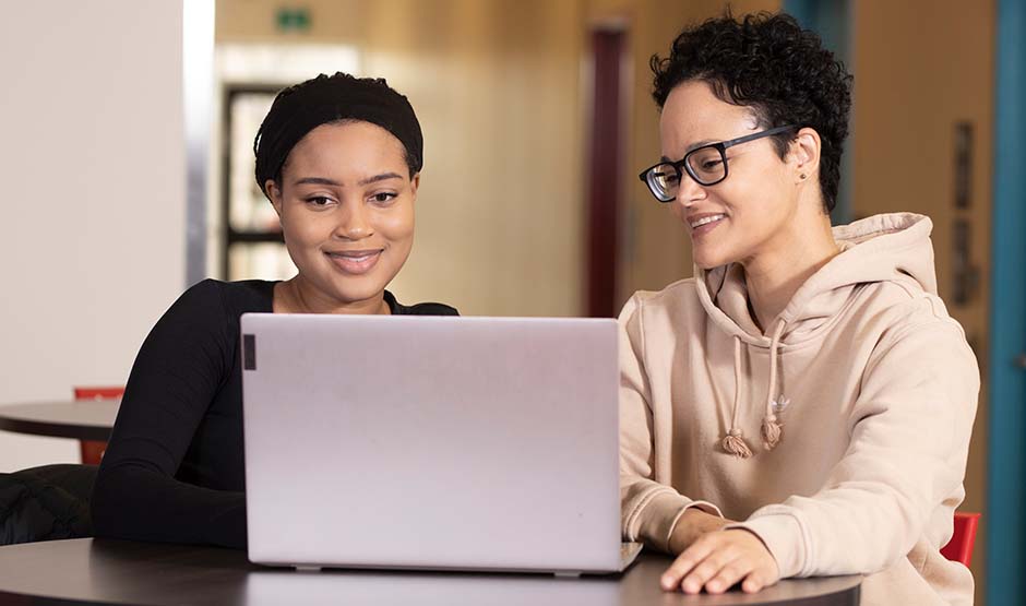 Two students working on the computer
