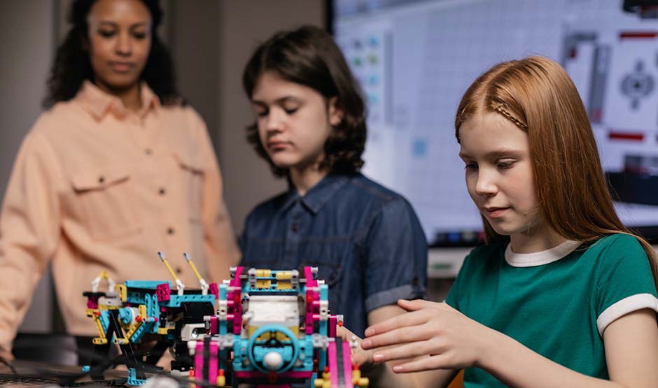 Summer Program - teacher and students in a Robotics Camp