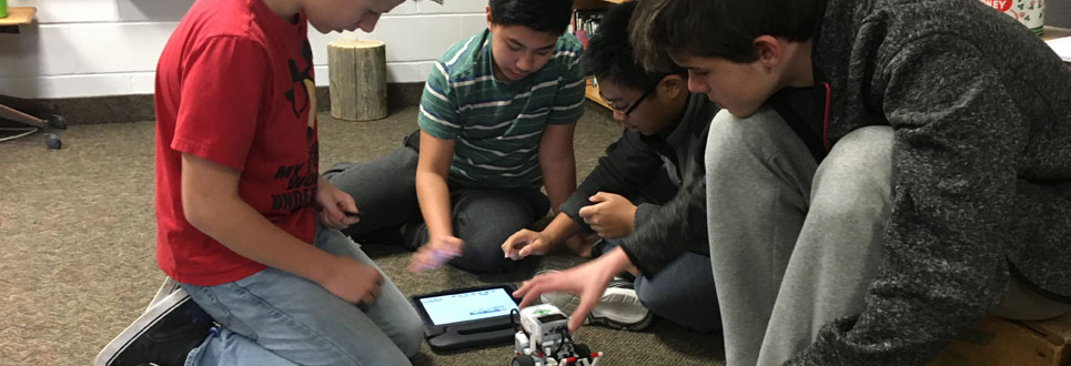 Males students building a robot